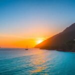 Labuan Bajo hotels and coastline at sunset.