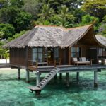 Komodo Island resort bungalow over turquoise water.