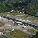 Labuan Bajo Airport with scenic coastal and hilly surroundings.